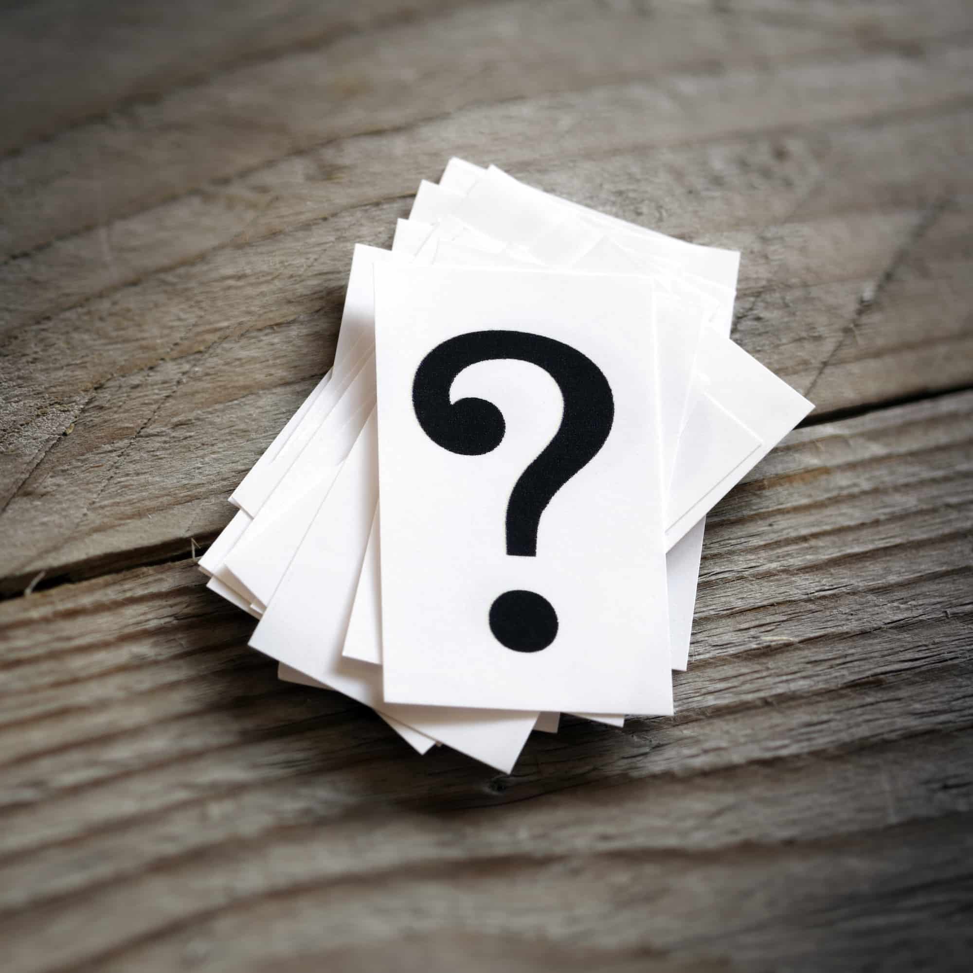 Question mark heap on table concept for confusion, question or solution